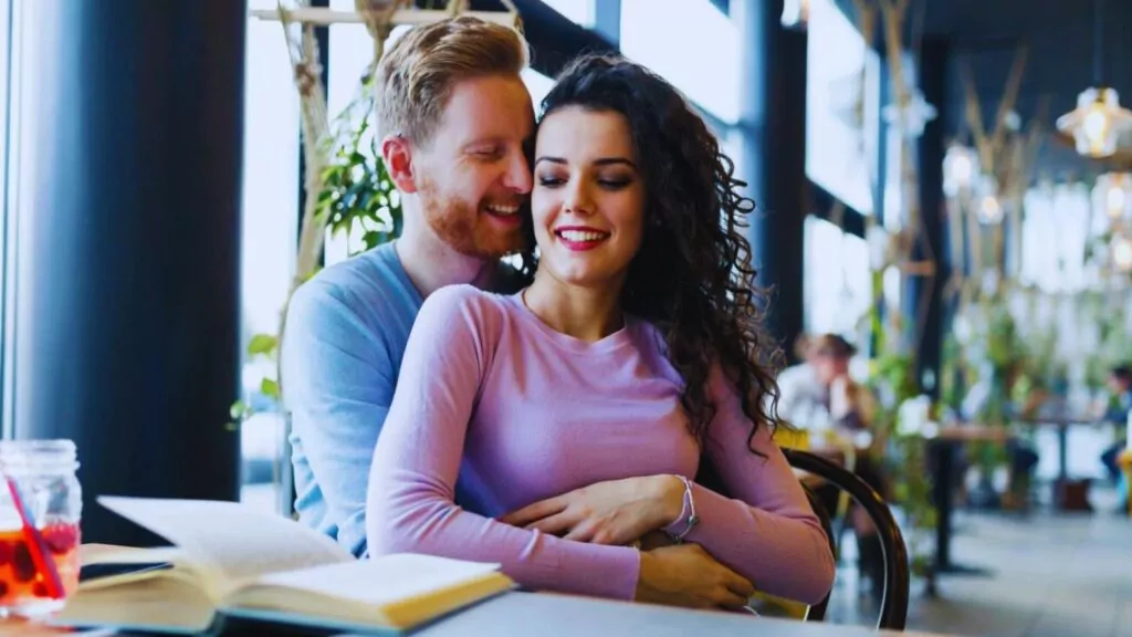 Young happy couple on date in coffee shop