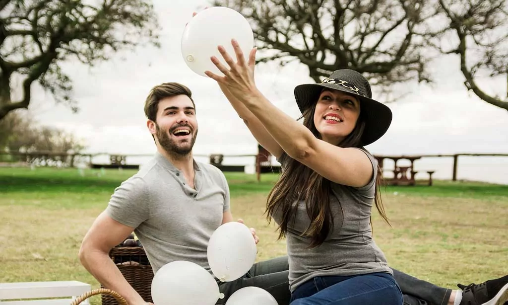 A cheerful couple enjoys a playful outdoor