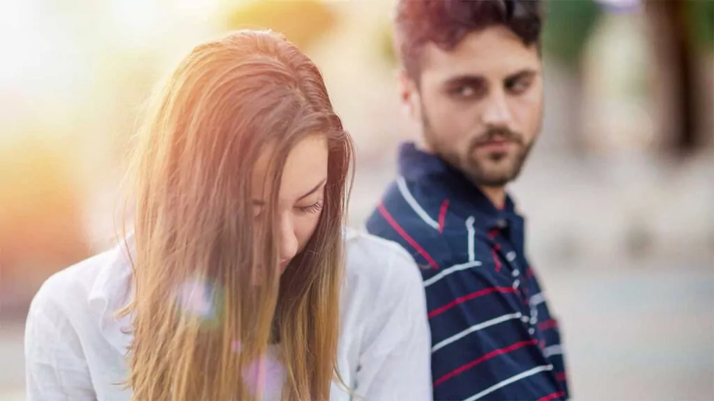 Couple facing away from each other with sad expressions during a tense moment